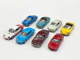 several toy cars are lined up in a row on a white surface