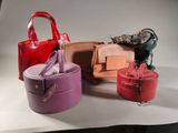 many different colored purses on display on a table