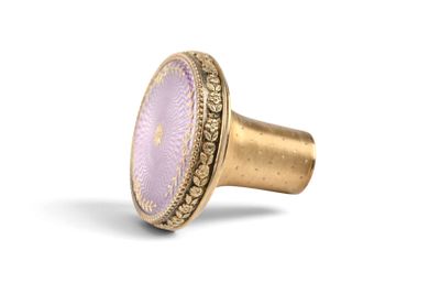 a close up of a ring with a purple stone on it