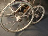 an old fashioned toy carriage with wheels on display