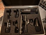 a bunch of microphones in a case sitting on a table