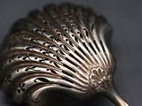 a silver spoon with a decorative design on it