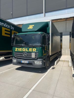 two trucks that are parked next to each other on the street