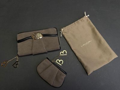 three pieces of luggage sitting on top of a table next to a bag