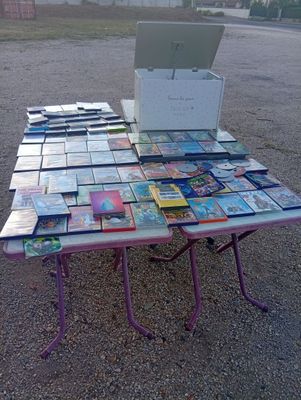 a lot of books on a table with a laptop on it