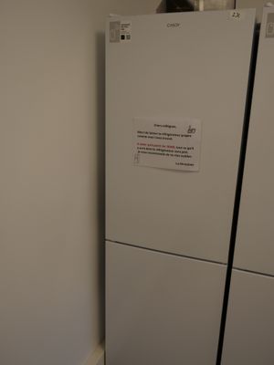 a white refrigerator and a white refrigerator freezer next to each other