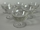 six wine glasses sitting on a table with a white background