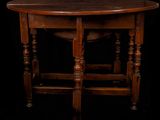an old wooden table with turned legs and a wooden top