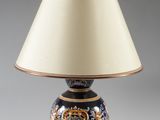an image of a blue and gold lamp with a white shade on it