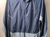 the jacket is hanging on a hanger on the wall