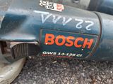 a close up of a bosch power drill on the ground