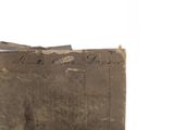 an old book with writing on it sitting on a table
