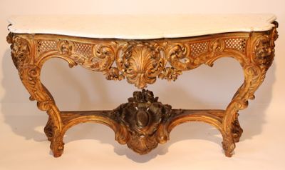an antique console table with a marble top and ornate carvings