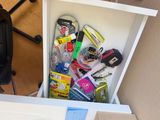 a white cabinet with a bunch of items inside of it