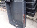 a pile of black plastic containers stacked on top of each other