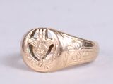 an image of a gold signet ring with a thistle design