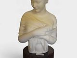 marble bust of a woman with her arms folded over her chest