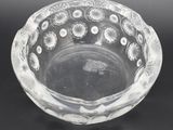a clear glass bowl on a black surface
