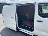 a white van with the door open and a hose in the back