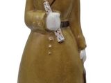 a ceramic figurine of a soldier with a bird on his shoulder