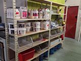 a shelf with many containers and containers on it in a garage