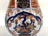 a vase with a design on it sitting on a table