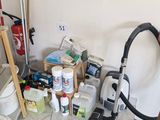 a room with a vacuum, buckets, and other cleaning supplies on the floor