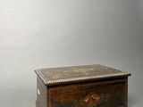 a small wooden box with a floral design on it