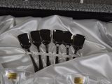 six wine glasses and six spoons in a box