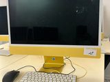 two computer monitors and a keyboard on the desk