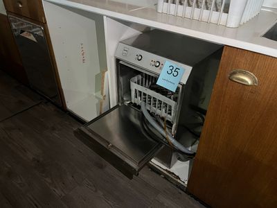 a dishwasher in the middle of a kitchen that is under the counter