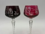 two wine glasses sitting next to each other on a table