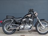 a black motorcycle parked in front of a garage door