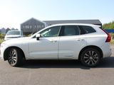 the white volvo suv is parked in the parking lot