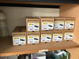 many boxes of shoes sitting on a shelf in a room
