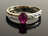 ruby and diamond ring on a reflective surface with reflection