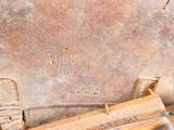 a close up of a rusty object on the ground