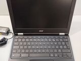 a laptop that is sitting on a table with a charger