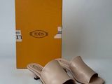 beige leather slippers with a box on a white surface