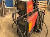 a machine that is sitting on the ground in front of a blue wall