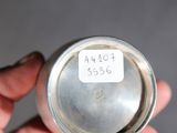 a person holding a silver cup with a tag on it
