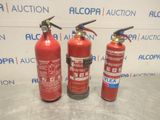 three red fire extinguisors sitting on top of a table