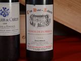 two bottles of wine sitting next to each other on a table