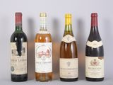 several bottles of wine are lined up on a table
