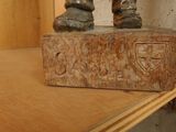 a statue of a man standing on top of a wooden block