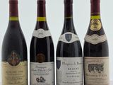 quatre bouteilles de vin sont alignées sur une table
