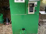 a green machine that is sitting in the dirt