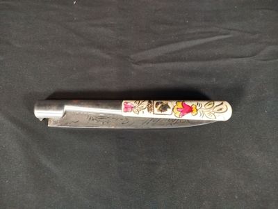 a knife that is laying on a black cloth