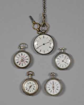 four different types of pocket watches hanging from a chain on a wall