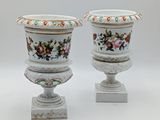 two vases that have been painted with flowers on them
